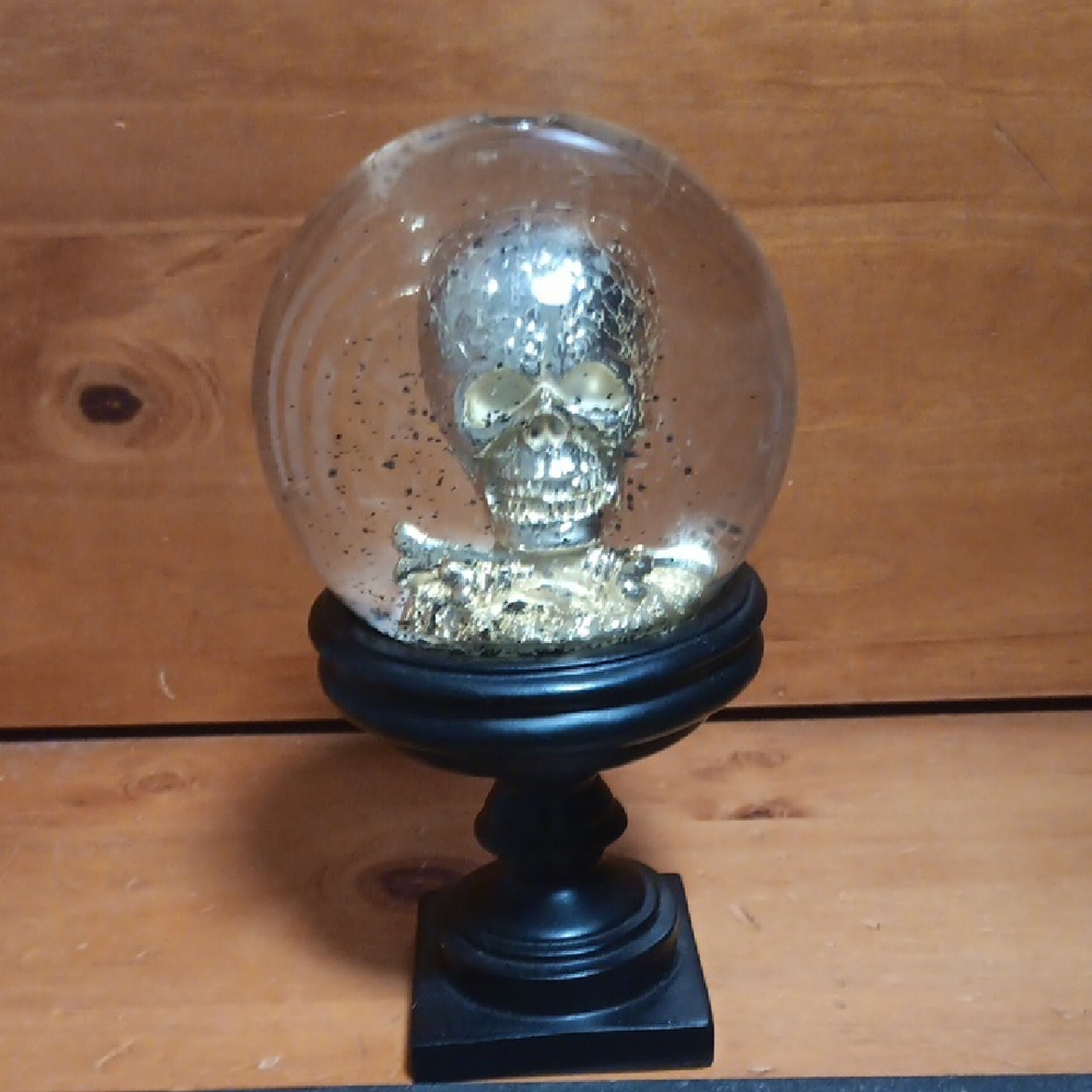 Gold Skull Snow Globe on Black Stand